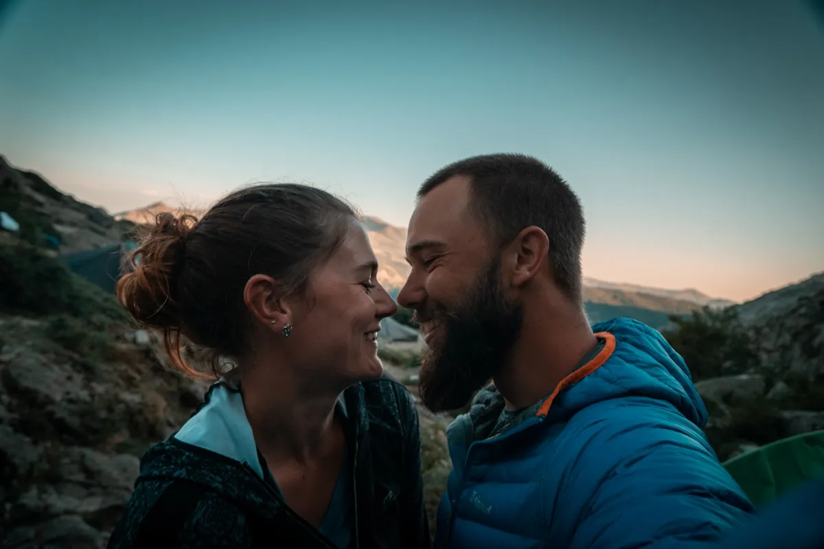 Travelling couple sharing a candid moment in a mountain setting