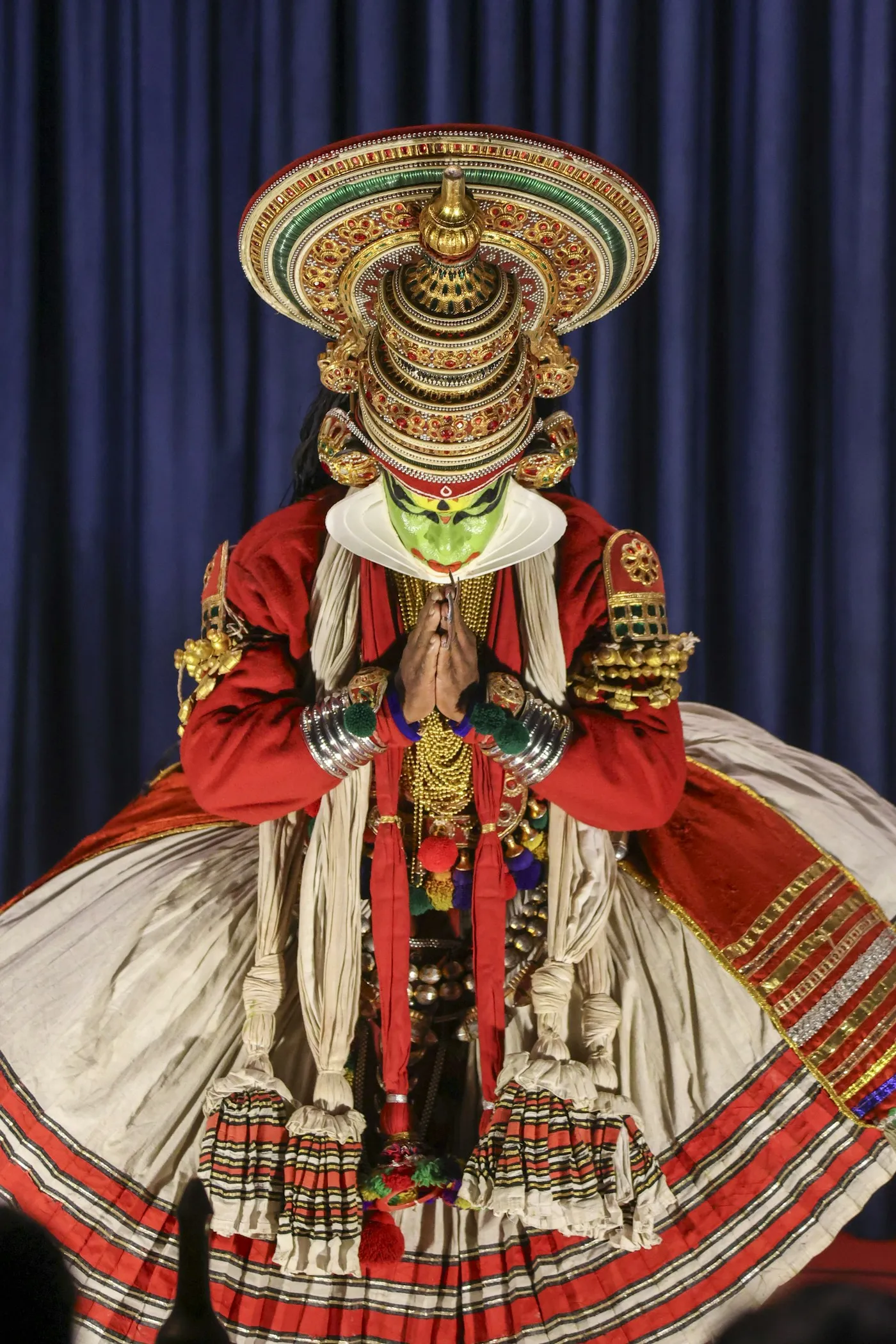 Kathakali performer wearing traditional costume and makeup