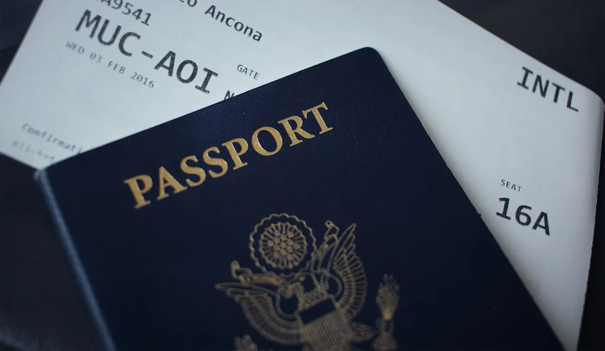 Passport placed on top of an international airline boarding pass