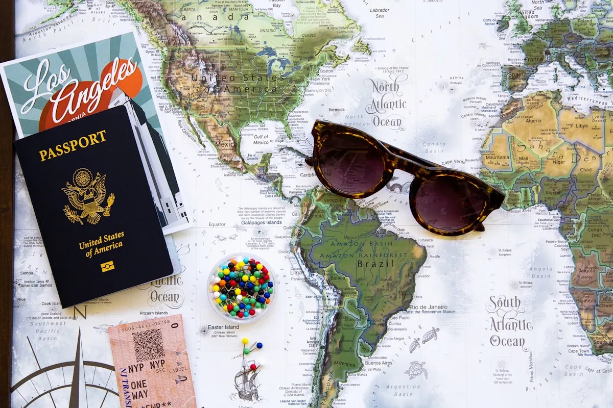 Passport, sunglasses and travel map arranged for an international journey