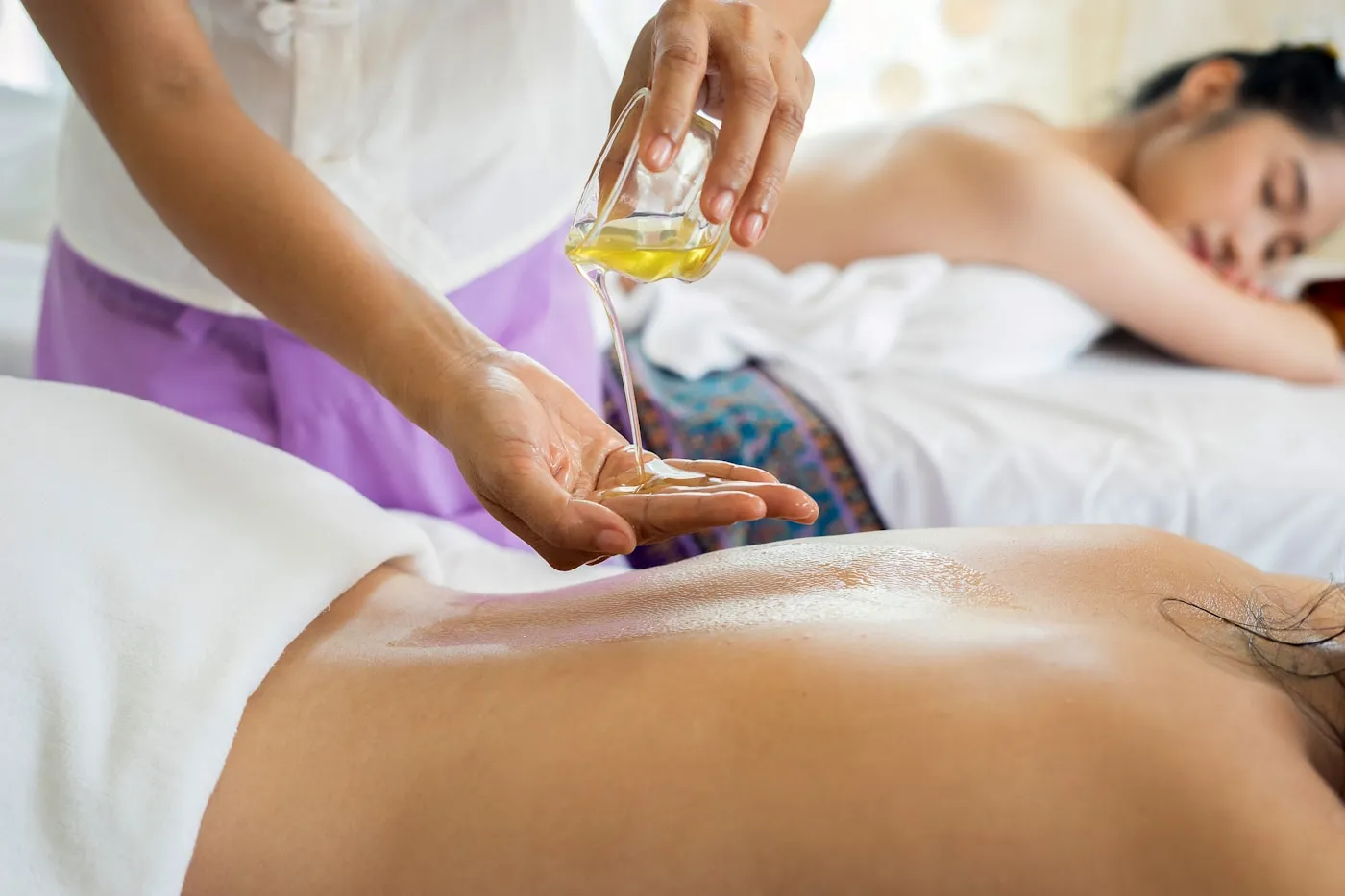 Guest receiving a relaxing oil massage at a spa